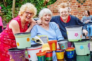 Isabel Mantle, manager at Elmbank, enjoys the new garden with some of the home’s residents